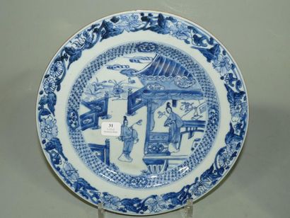 CHINE Assiette ronde à décor en bleu sous couverte de dames dans un jardin. XVIIIè...