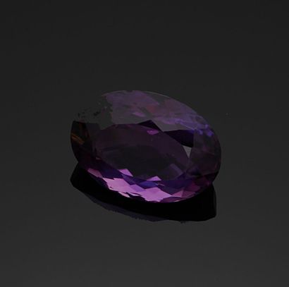 null Oval-shaped amethyst on paper weighing 113.15 carats.