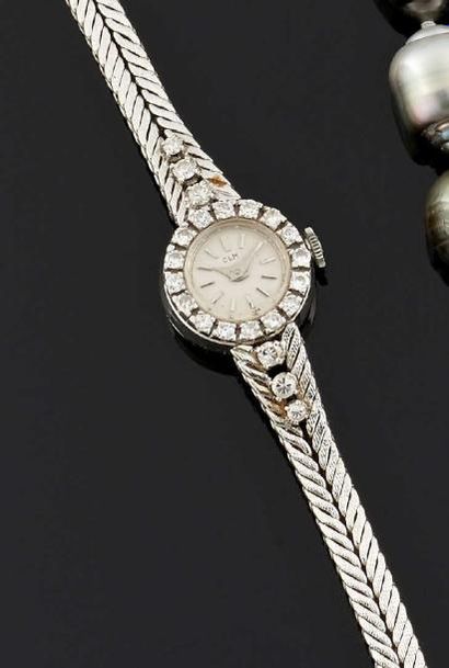 CLM Montre-bracelet de dame en or gris 18 k (750°/oo), la montre de forme ronde,...