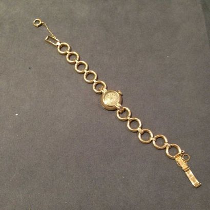 null Montre bracelet de dame en or jaune 18 k, de forme ronde, le bracelet articulé...