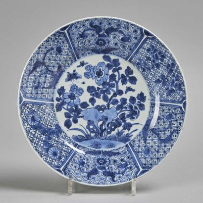 CHINE Plat rond en porcelaine à décor en bleu sous couverte de rocher percé et arbuste...