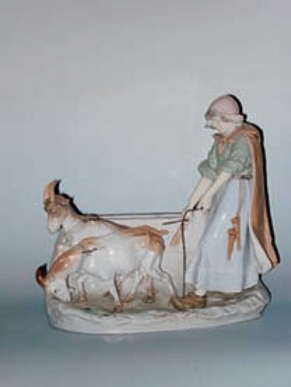 AMPHORA Sujet en porcelaine présentant une jeune bergère et ses chèvres sur une terrasse...