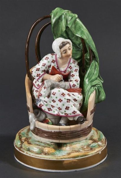 null NIDERVILLER. Groupe en porcelaine représentant la ravaudeuse, décor polychrome....