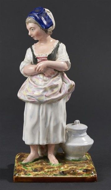 null EST. Statuette en faïence représentant une jeune femme près d'un pot couvert,...