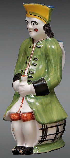 NORD Pichet «Jacquot» représentant un homme vêtu d'un grand manteau vert et portant...