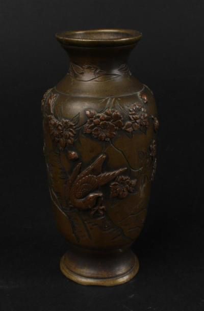 null CHINE - 
Petit vase en bronze à patine médaille à décor en relief d'un oiseau...