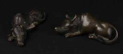 null JAPON, XIXe siècle - 
Deux bovins couchés en bronze. 
Long. 9,5 cm et 10,5 cm...