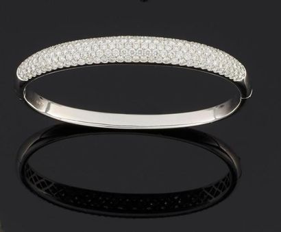 null Bracelet rigide ouvrant en or gris 750°/oo, le centre orné d'un pavage de diamants...