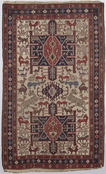 null TAPIS en soie à décor d'animaux stylisés sur fond beige. 
H. 162 cm - Long....