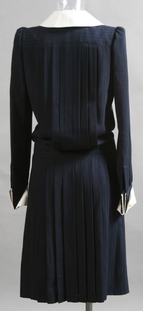 null YVES SAINT-LAURENT. Navy blue pleated Haute Couture dress with white collar....