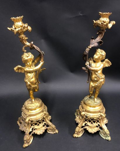 null Imposing pair of gilt bronze candlesticks with cherubs. XIXth century.
