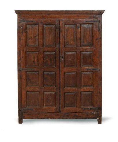 null A small walnut wardrobe opening with two leaves decorated with flower bed panels....