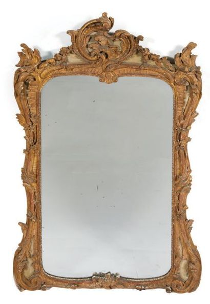  MIRROR in molded, carved, gilded and green rechampi wood. Amounts with foliage running,...