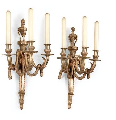 null PAIR OF WALLS in chased and gilded bronze with three arms of light. A shaft...