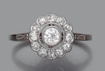 null BAGUE en or gris 14K (585) repercée d'un motif floral stylisé serti de diamants...