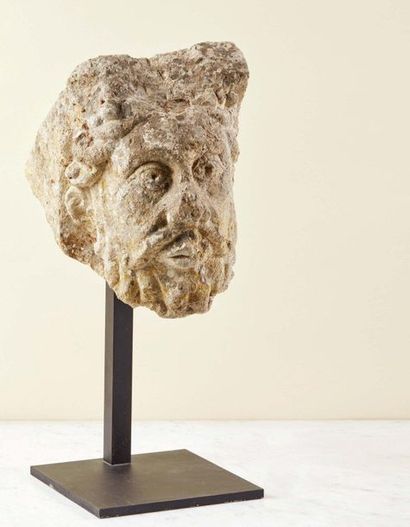 null Carved stone modillon representing a bearded man's head.
Face with prominent...