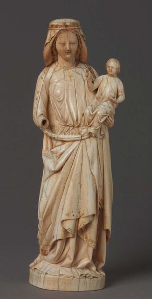 null Virgin and Child in carved ivory with rare polychrome remains. Standing with...