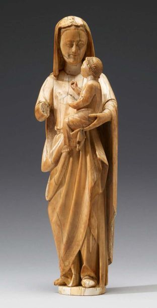 null Virgin and Child in carved ivory with rare polychrome remains. Standing with...
