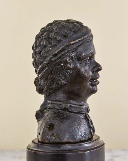 null Bust of a young African slave in bronze with brown patina. Wearing an iron necklace...