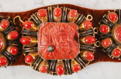 null Coral harness with a cast silver, gilded and enamelled frame, sewn on a red...