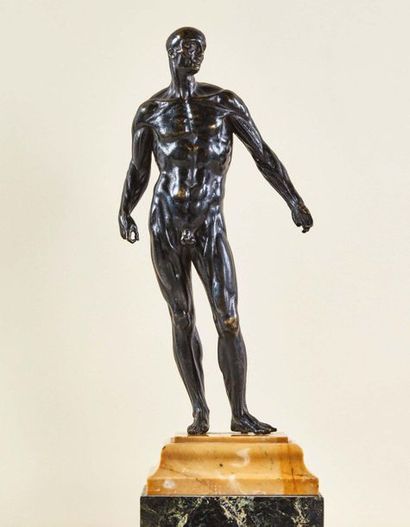 null Flayed in bronze with a black patina. Standing in a slight contrapposto, the...