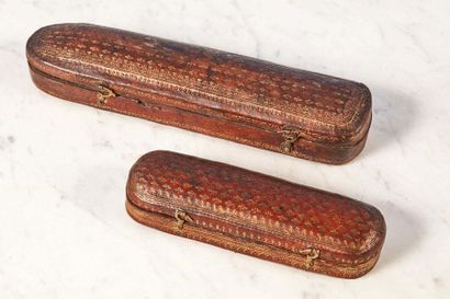 null Lot composed of two cases:
- Leather case gilded with a small iron decorated...