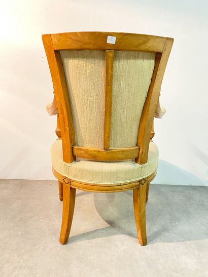 null Armchair In natural wood formerly lacquered, moulded and carved, the armrest...