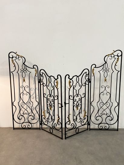 null Pair of wrought and gilded iron dividing grids, decorated with scrolls and volutes...
