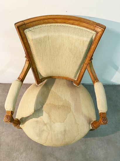 null Armchair In natural wood formerly lacquered, moulded and carved, the armrest...