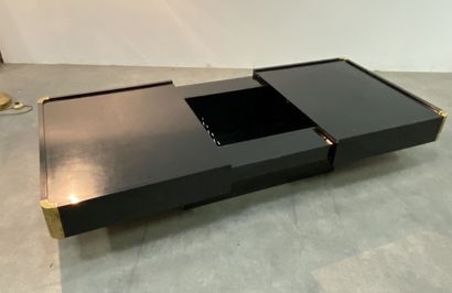 null Black coffee table decorated with gilded brass corners, the top revealing a...