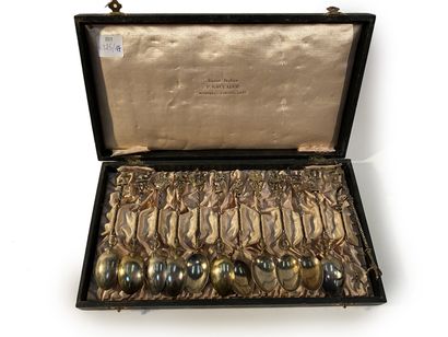  Chest containing eleven spoons and one tongs Made of silvery metal