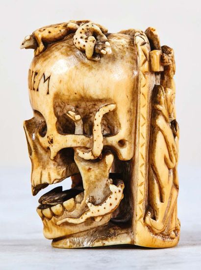 null Exceptional memento mori in carved and engraved ivory with red highlights. Skull...