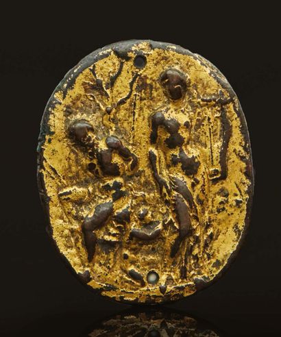 null Oval gilt bronze plaque representing Apollo standing holding his lyre and Marsyas...