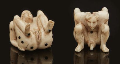 null Pair of erotic ivory and ebony playing dice carved in the round, representing...
