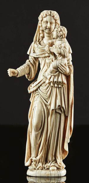null Virgin and Child in ivory sculpted in the round.
Standing on her left leg, with...