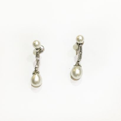 null 
Pair of 14K white gold earrings with a button cultured pearl holding a line...