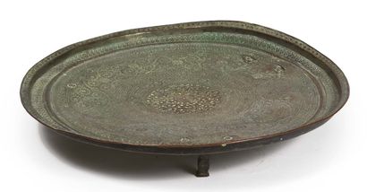 null TRIPOD TRAY. Tinned copper with engraved decoration. Resting on three small...