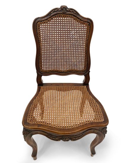 null Pair of caned chairs In moulded and suclted natural wood, the backs are crowned...