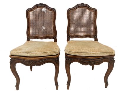 null Pair of caned chairs In moulded and suclted natural wood, the backs are crowned...