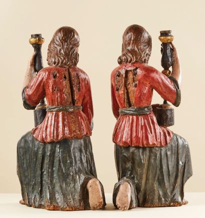 null Pair of ceroferous angels in wood carved in the round, polychromed and gilded....