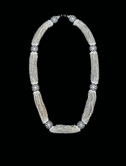 null A finely carved marine ivory necklace consisting of eight openwork rosette-shaped...