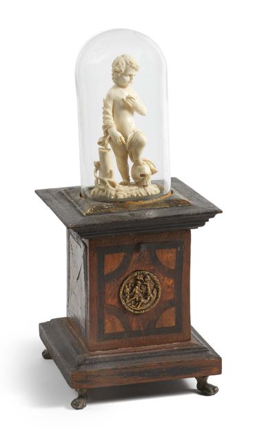 null Ivory Child Jesus carved in the round, vanity. Standing next to a tree, his...