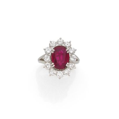 null Platinum daisy ring set with an oval ruby (weighing approximately 2.5 carats)...