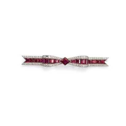 null A platinum barrette brooch with a knot of calibrated red stones set with old...