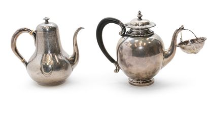 null Lot including a silver teapot and a silver plated teapot. A silver plated tea...