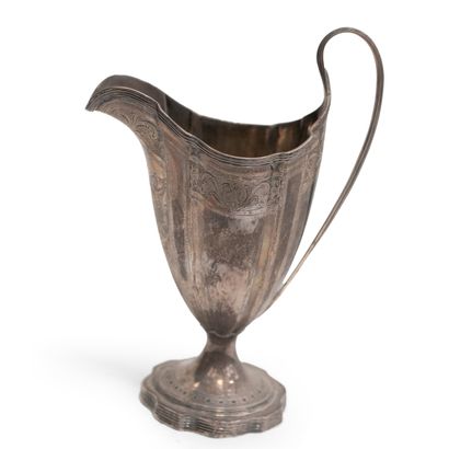 null Polylobed silver jug with filets and foliage and floral frieze and filets handle....
