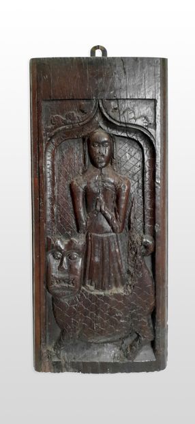 null 
Carved oak panel representing Saint Margaret in prayer coming out of the body...