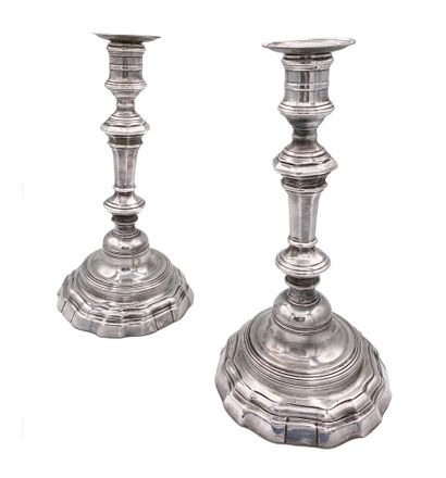 null A pair of torches and their wicks in silver plated metal with contours and balusters...