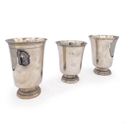 null A set of three plain silver kettledrums, the feet bordered with a frieze of...