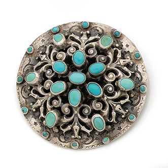 null Broche en argent (800) ciselé de forme circulaire, à décor de cabochons de turquoises...